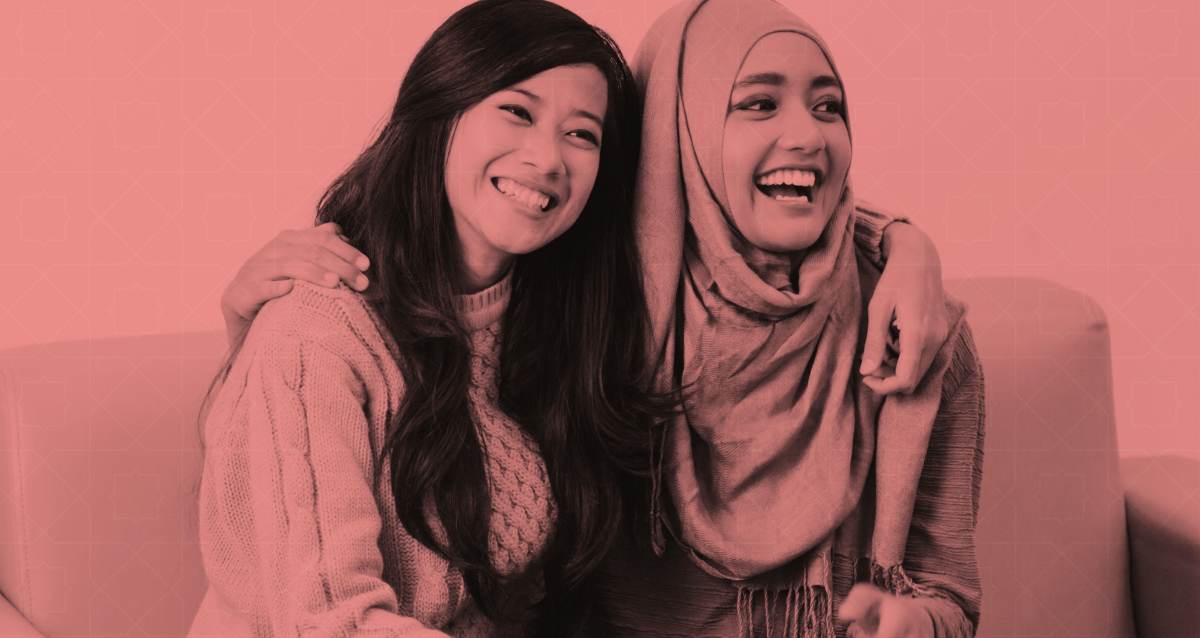 Two women sitting together, laughing